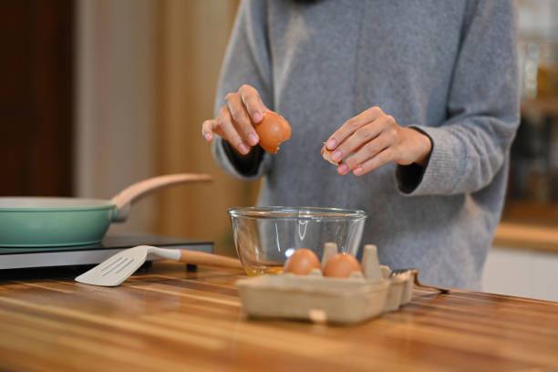 istock Smiling young asian woman preparing breakfast in her kitchen 2174097481