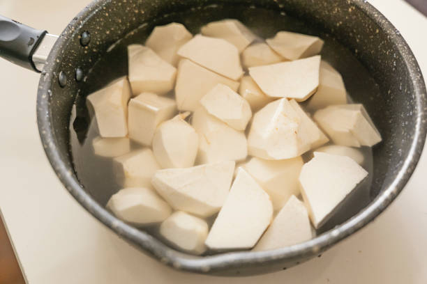 Taro being cooked, peeled and lye removed