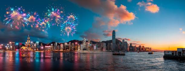 istock A city skyline with fireworks and a sunset, reflected in the water. 2174097738