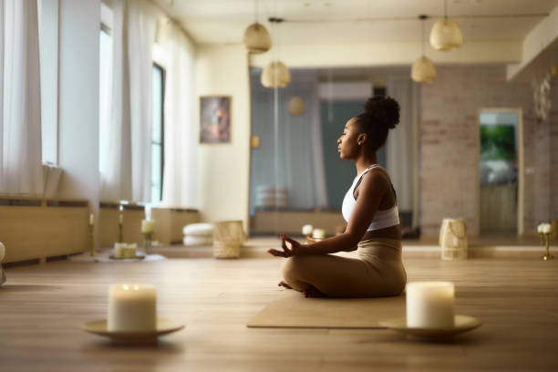 istock Young black woman meditating at Yoga studio. 2174097801