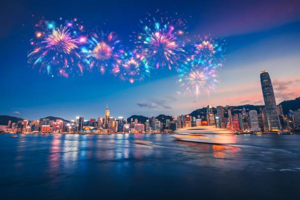 istock Fireworks explode over a Hong Kong cityscape at twilight, reflecting in the water. 2174098124