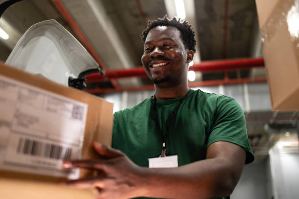 Loading delivery van with packages and parcels. Postal worker losing his truck with packages preparing for delivery. sorter machine stock pictures, royalty-free photos & images