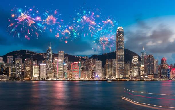 istock Nighttime cityscape with fireworks over a harbor. 2174100399