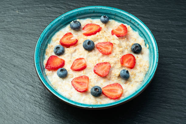 istock Homemade breakfast . Oatmeal with milk and berries . Top view 2174103229