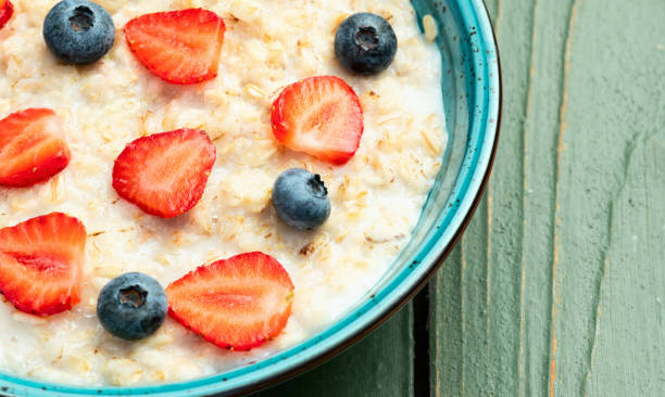 istock Homemade breakfast . Oatmeal with milk and berries . Top view 2174103235