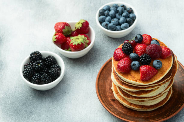 istock Stack of homemade american pancakes with berries . Top view 2174103237