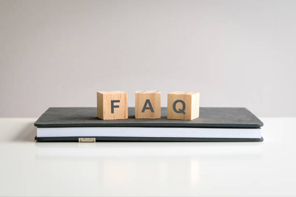 istock Text FAQ on wooden blocks on top of a notepad. 2174103376