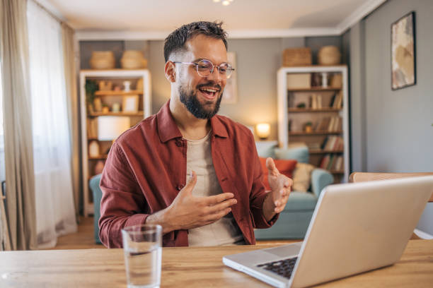 istock A mid adult handsome man using her laptop for video call. 2174103406