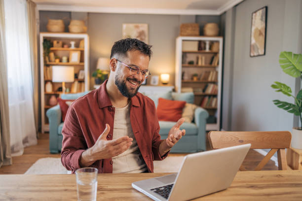 istock A mid adult handsome man using her laptop for video call. 2174103412