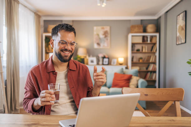 istock A mid adult handsome man using her laptop for video call. 2174103796