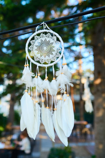 istock A decorative dreamcatcher hanging in a serene outdoor setting under soft sunlight 2174103920