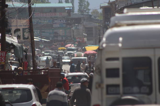 Srinagar, Jammu & Kashmir, India - May 02, 2024: People traveling on the read in their cars and bikes and enjoying the ride in the city of Srinagar, Jammu and Kashmir.