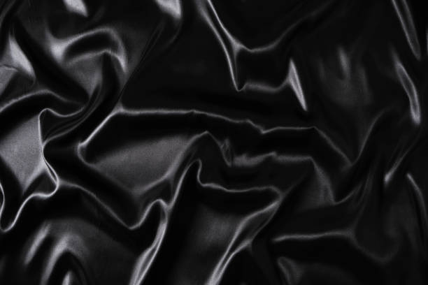 Silk fabric, abstract wavy black satin fabric background