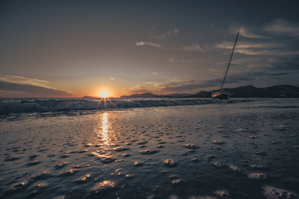 boat on the beach at sunset, sailboat stranded on the beach in France