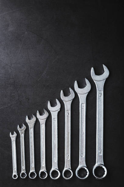 istock A set of wrenches on a textured black background in a row. 2174109560