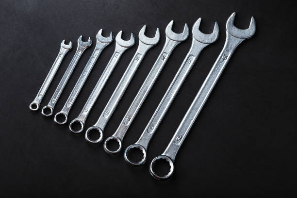 istock A set of wrenches on a textured black background in a row. 2174109608
