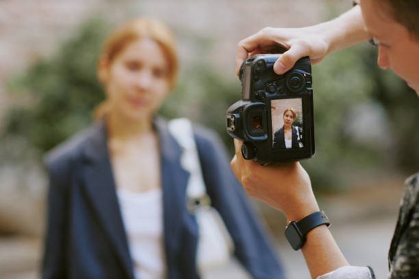 istock Photographing Woman With Camera in Exterior Setting 2174110220