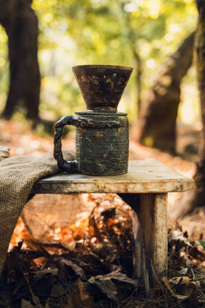 istock Handmade Ceramic Coffee Mug on Wooden Table in Forest 2174110839