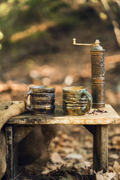 istock Handmade Mugs and Coffee Beans in Forest Setting 2174110890