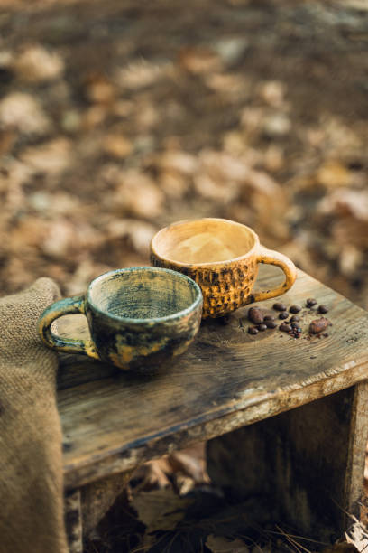 istock Rustic Coffee Mugs and Burlap Cloth on Wooden Table 2174110910