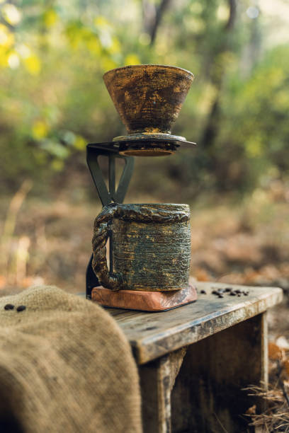 istock Rustic Ceramic Coffee Filter and Mug on Wooden Table in Nature 2174110987