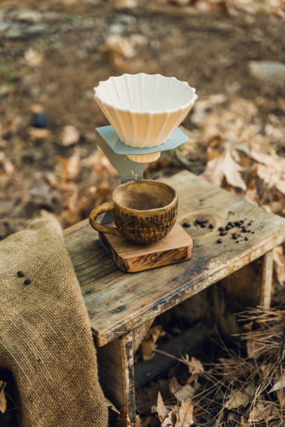 istock Ceramic Coffee Filter and Mug Set on Wooden Table in Natural Setting 2174111016