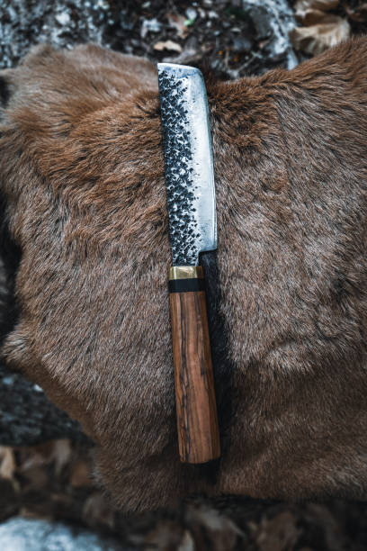 istock Hand-Forged Knife with Wooden Handle on Fur Background 2174111300