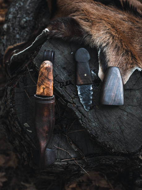 istock Handmade Knives and Leather Sheaths Set on a Tree Stump 2174111378