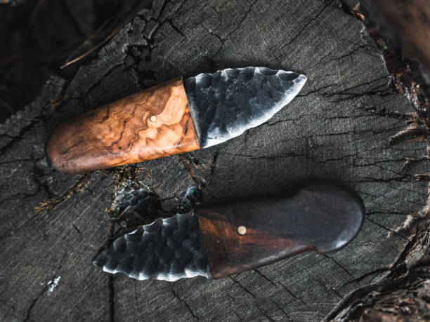 istock Close-up of Handcrafted Stone Knives on a Tree Stump 2174111414