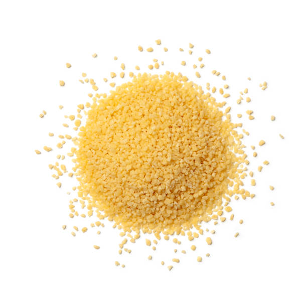 Heap of dried uncooked couscous on white background