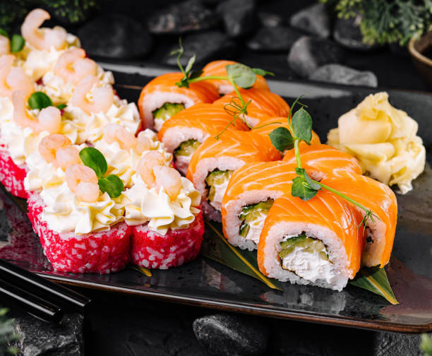 istock Delicious sushi rolls being served on black stone plate 2174117854