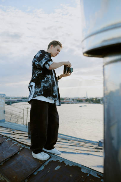 Man Positioning Camera for Rooftop Photography Session