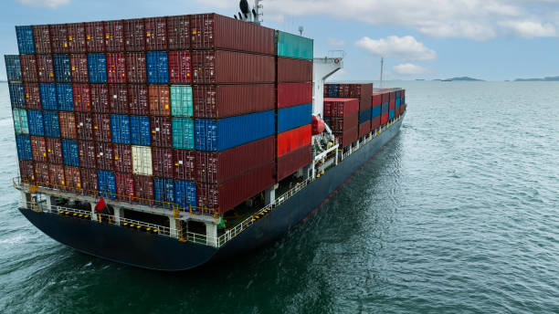 istock Aerial rear view Container Ship load container going to seaport or unload at container warehouse on the green sea. Logistics, import export, shipping or transportation Asia Pacific 2174123266