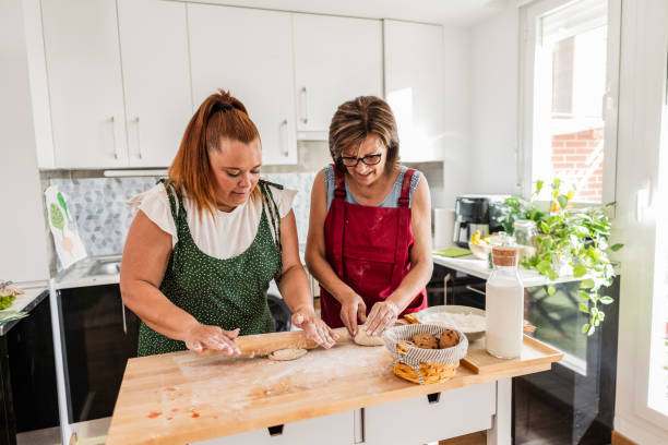 istock Mother and grandmother kneading dough together in kitchen 2174128201