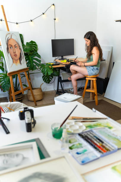 istock Female illustrator drawing with a tablet in her art studio 2174130483