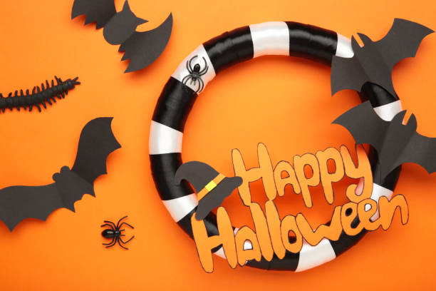 istock Halloween wreath on orange background. Thanksgiving decor. Top view 2174131269