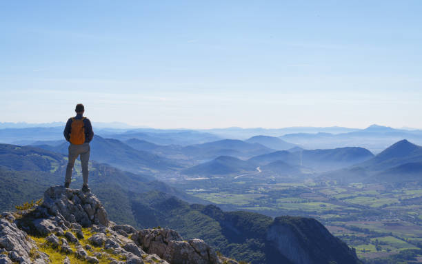 Hiker looking at the landscape. Sakana Valley from the Aralar mountain range, Navarra.