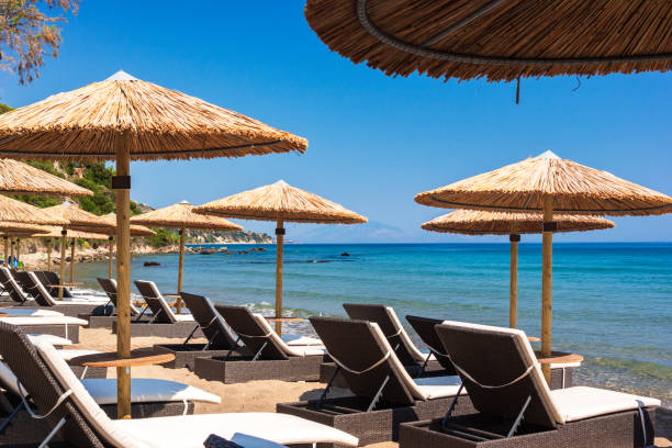 istock Summer beach scene with sunbathers and umbrellas 2174132474