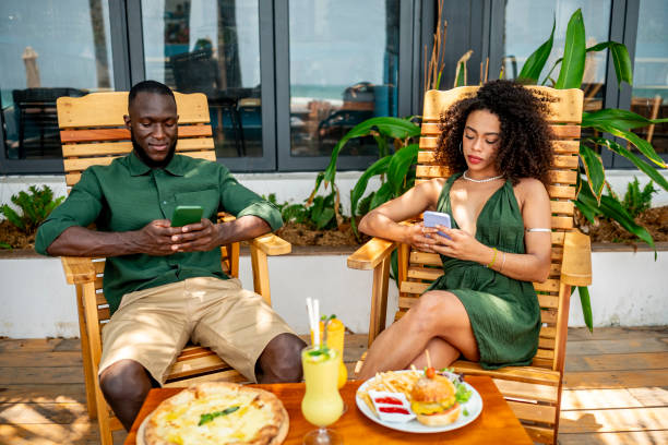 istock Casual Outdoor Dining with Friends Using Smartphones 2174132808