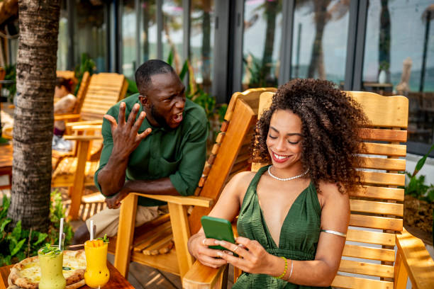 istock Woman Enjoying Vacation While Man Expresses Surprise or Frustration 2174132820