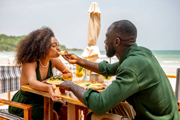 istock Romantic Beachside Dining with a Couple Sharing Food 2174132861