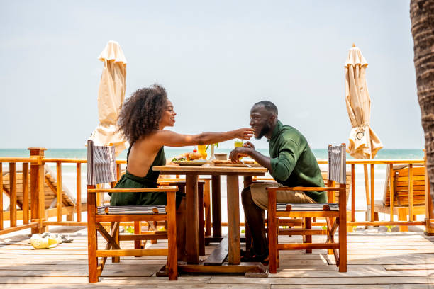 istock Couple Enjoying a Romantic Beachside Lunch Together 2174132880