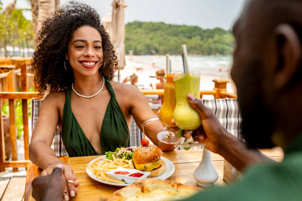 istock Couple Enjoying Lunch and Drinks at Beachside Restaurant 2174132909