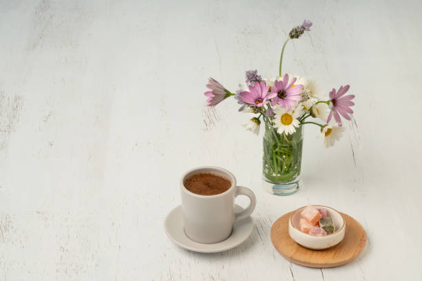 istock cup of Turkish coffee and delight on table with flowers 2174135129