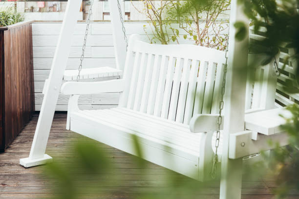 istock White wooden swing on the cafe terrace, bench for rest. 2174136302