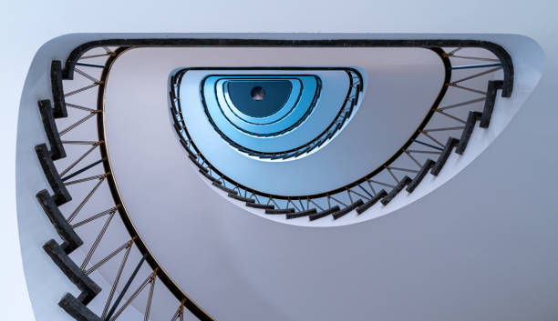 Germany, Berlin, Charlottenburg, August 13, 2024 - Low angle view of modern spiral staircase