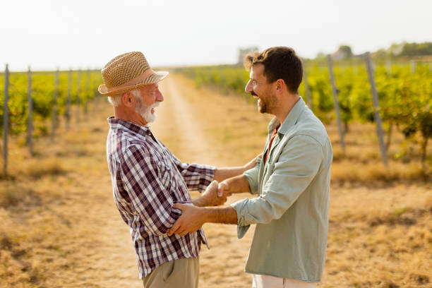 istock Heartfelt conversation between two generations in a sunlit vineyard during late afternoon harvest season 2174137686