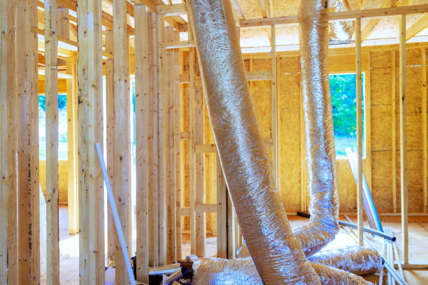 istock Installing silver insulation ventilation HVAC pipes on ceiling to roof of a construction process 2174137920