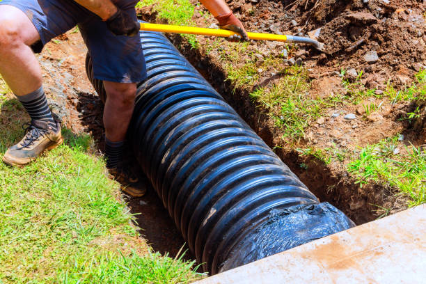 istock Installation of drainage black pipes in a trench during construction 2174137946