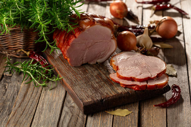 istock Smoked pork ham on a wooden table. 2174138555